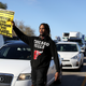 A Black Lives Matter protester holds a sign as he marches on Interstate 5 during a demonstration on March 22, 2018, in Sacramento, Calif.